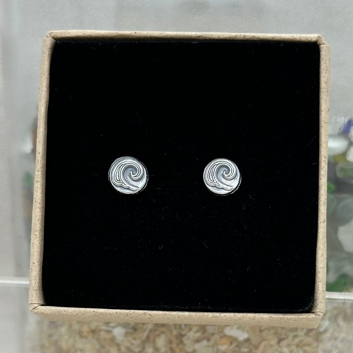 A sterling silver wave pebble stud earrings in an Impressums Jewellery branded gift box, ready for gifting.