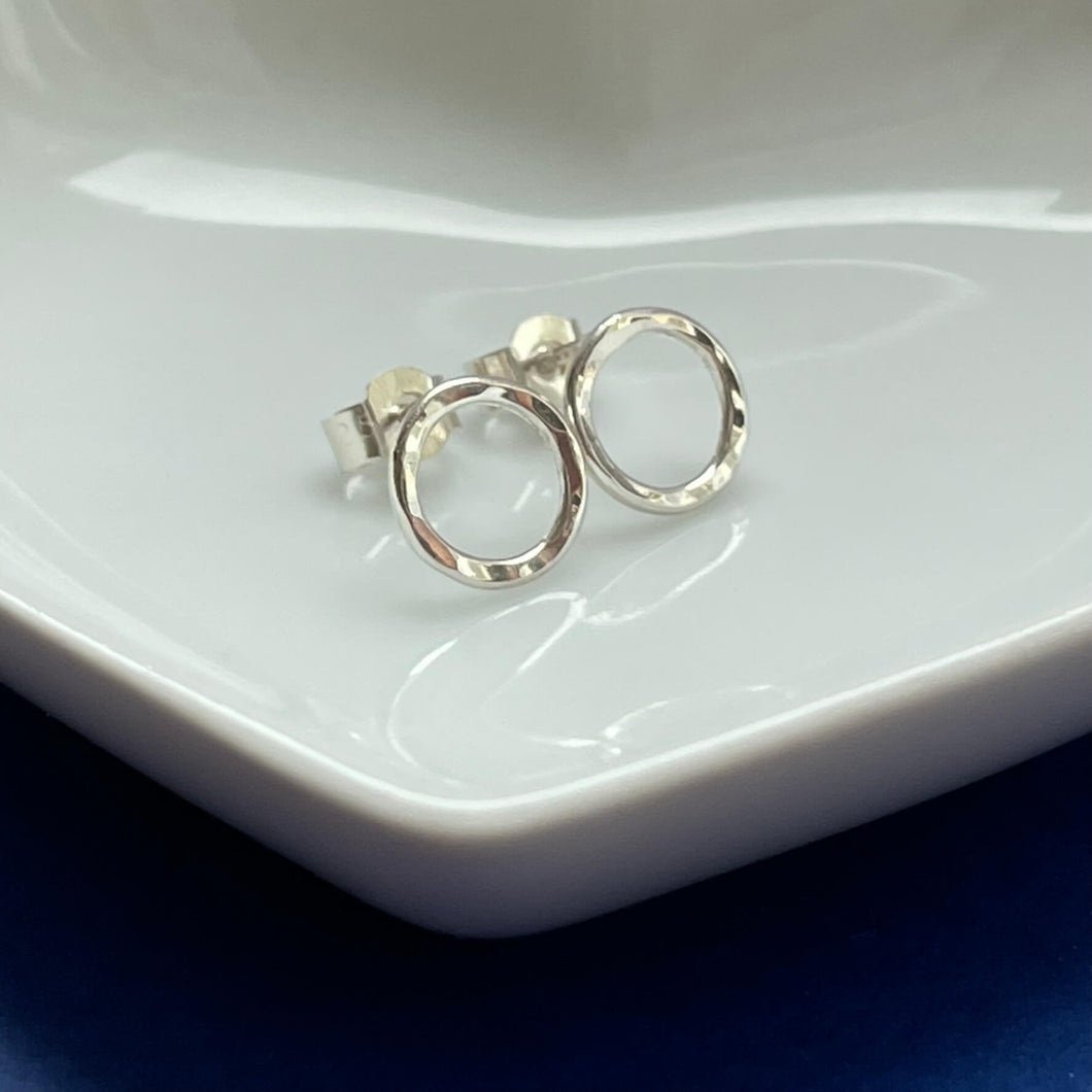 Sterling Silver Earrings in a round circle shape with a hammered texture. Shiny Sterling Silver Hammered Circle Earrings.