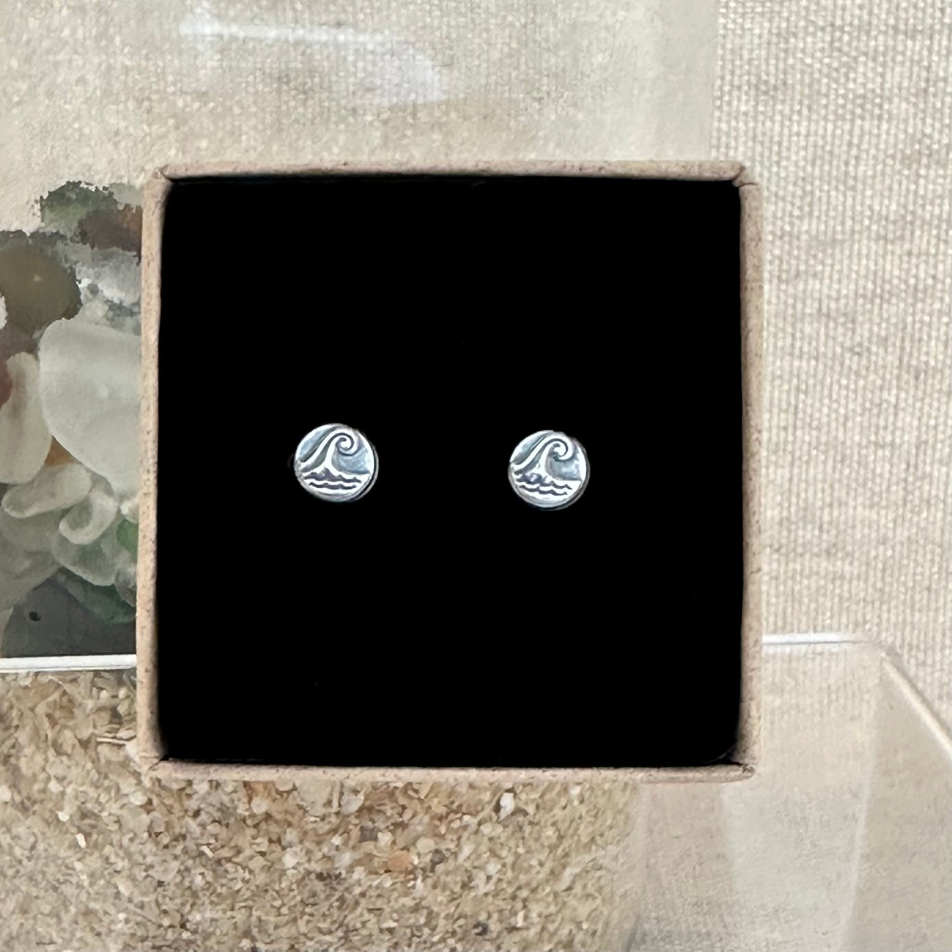 A sterling silver wave pebble stud earrings in an Impressums Jewellery branded gift box, ready for gifting.