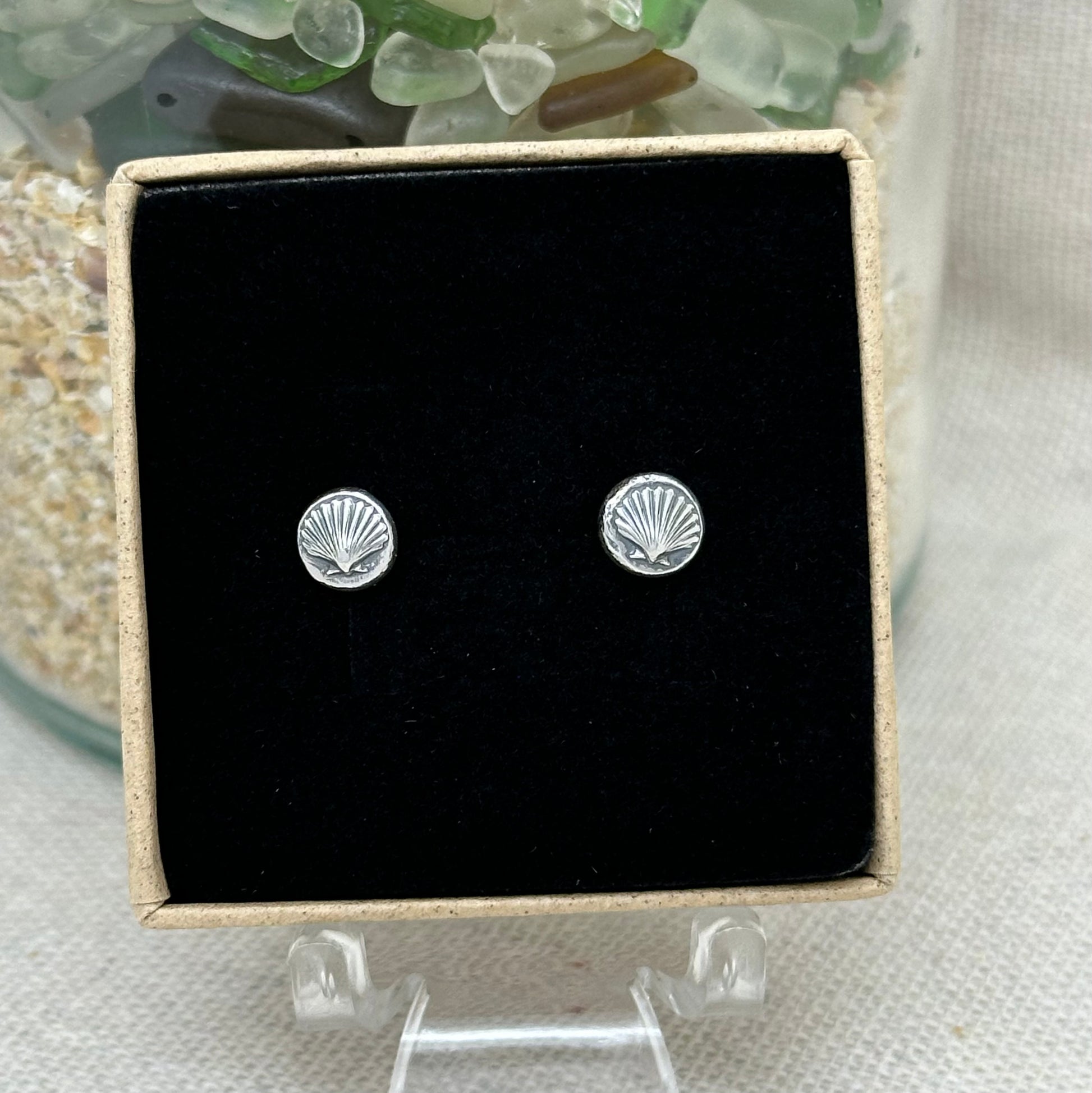 A sterling silver shell pebble stud earrings in an Impressums Jewellery branded gift box, ready for gifting.