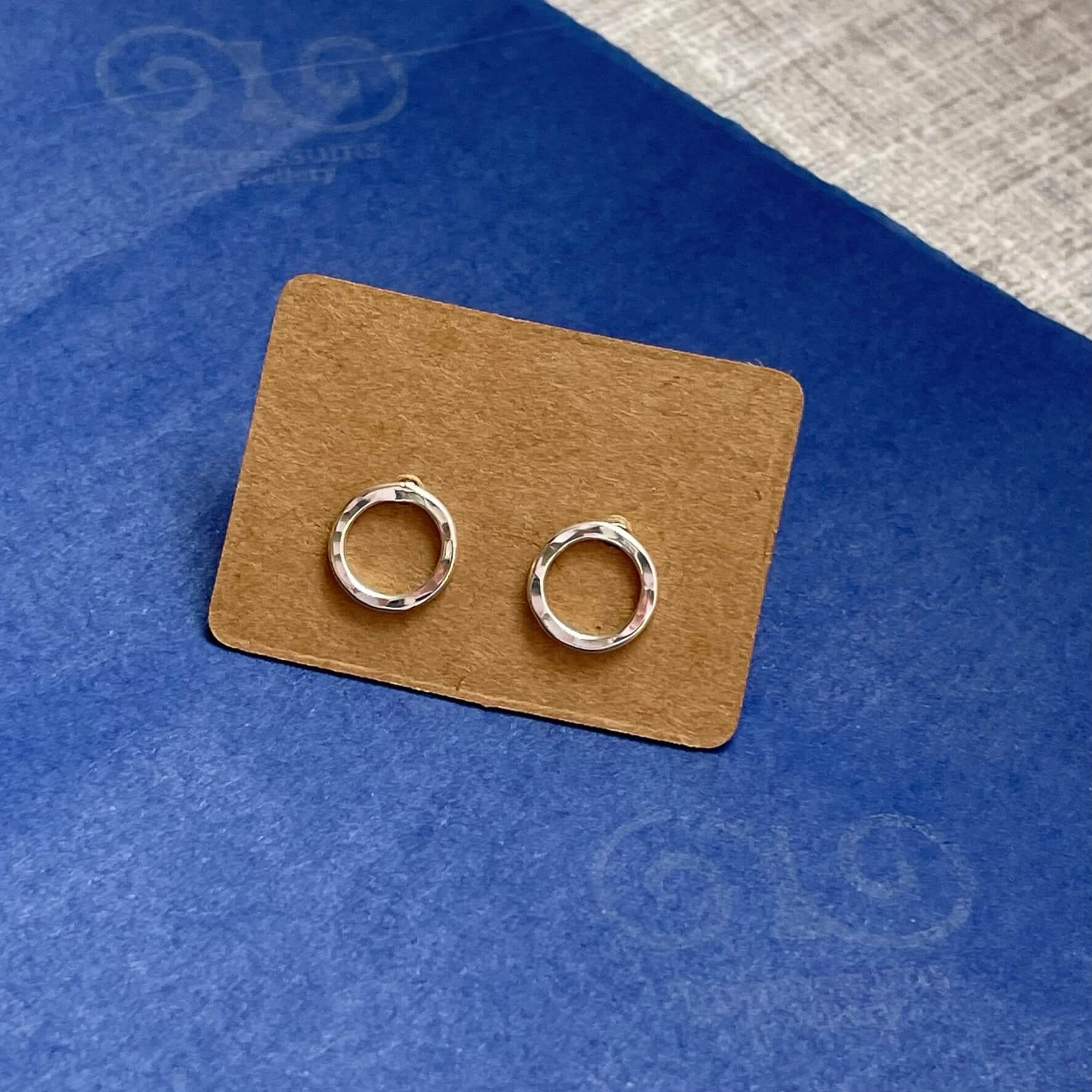 A pair of Sterling Silver Hammered Texture Circle Earrings pictured without a gift box,