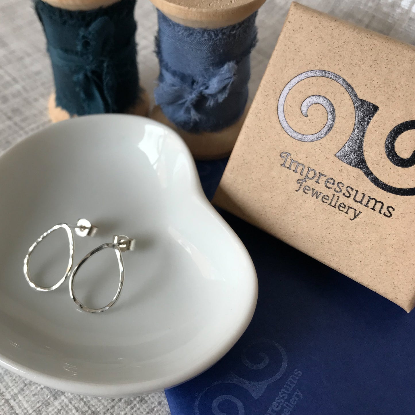 A pair of sterling silver open teardrop stud earrings, beautifully presented with a branded Impressums Jewellery gift box